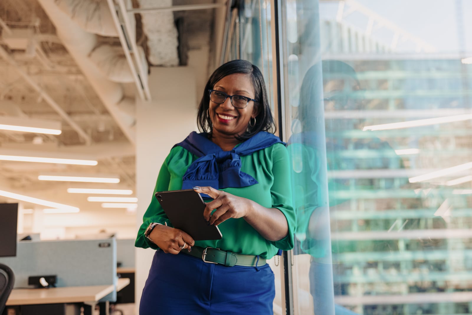 A businesswoman working confidently in an office, representing digital inclusion.